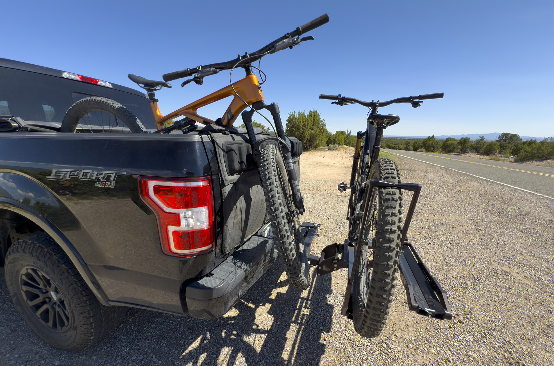 1UP USA Super Duty Rack anchored to the RakAttach swing-out hitch mount